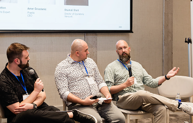 Barrett Ahern speaking at the Yotpo Partner Day event panel with three colleagues.